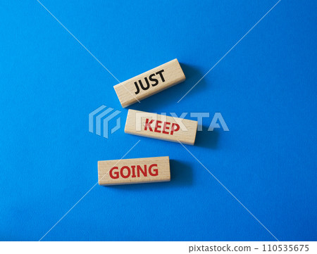 Just keep going symbol. Concept words Just keep going on wooden blocks. Beautiful blue background. Business and Just keep going concept. Copy space. 110535675