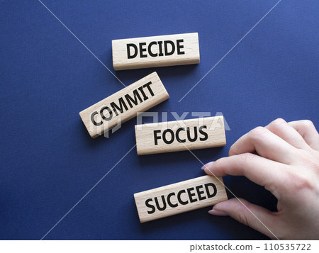 Decide Commit Focus Succeed symbol. Concept words Decide Commit Focus Succeed on wooden blocks. Businessman hand. Beautiful deep blue background. Business concept. Copy space. Decide Commit Focus Succeed symbol. Concept words Decide Commit Focus Succeed on wooden blocks. Businessman hand. Beautiful deep blue background. Business concept. Copy space. 110535722
