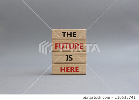 The future is here symbol. Concept words The future is here on wooden blocks. Beautiful grey background. Business and The future is here concept. Copy space. 110535741