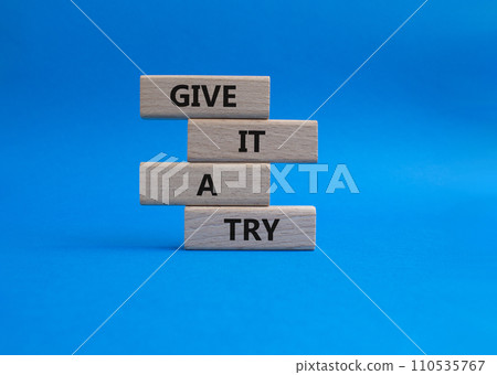 Give it a try symbol. Concept words Give it a try on wooden blocks. Beautiful blue background. Business and Give it a try concept. Copy space. 110535767