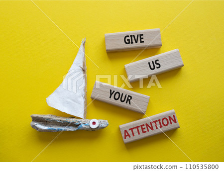Attention symbol. Concept word Give us your attention on wooden blocks. Beautiful yellow background with boat. Business and Give us your attention concept. Copy space Attention symbol. Concept word Give us your attention on wooden blocks. Beautiful yellow background with boat. Business and Give us your attention concept. Copy space 110535800