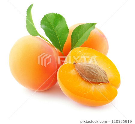 Ripe apricot fruits , one cut in half to reveal a stone, isolated on white 110535919