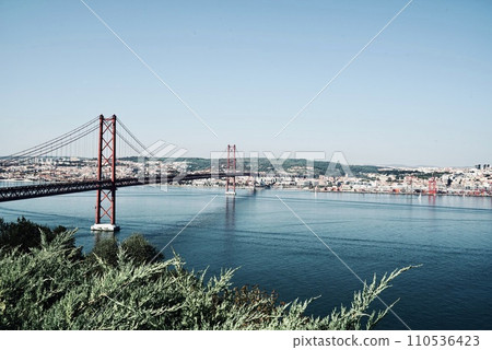 View of the Tagus River in Lisbon with the bridge of the Ponte 25 de Abril, Lisbon Portugal 110536423