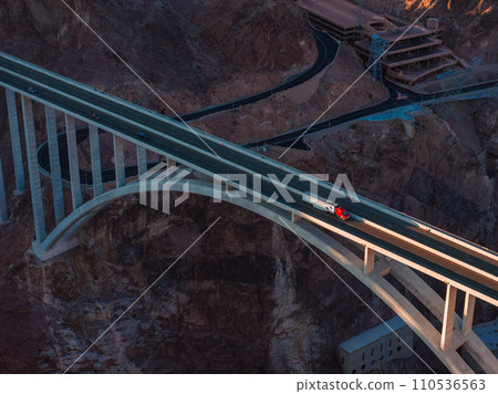 Hoover Dam on the Colorado River straddling Nevada and Arizona at dawn from above. Aerial view of Hoover Dam and the Colorado River Bridge Hoover Dam on the Colorado River straddling Nevada and Arizona at dawn from above. Aerial view of Hoover Dam and the Colorado River Bridge 110536563