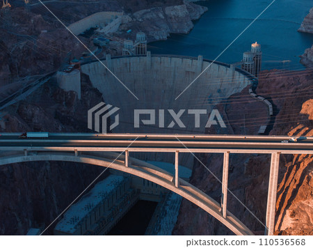 Hoover Dam on the Colorado River straddling Nevada and Arizona at dawn from above. Aerial view of Hoover Dam and the Colorado River Bridge 110536568