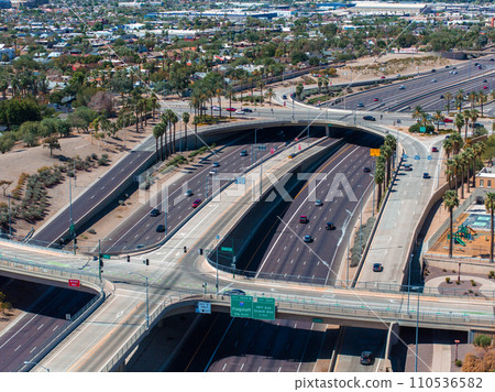 Aerial view of the highway and crossroads intersections in Phoenix, USA. Top up aerial drone view of elevated road and traffic junctions in USA metropolis during sunny day. Aerial view of the highway and crossroads intersections in Phoenix, USA. Top up aerial drone view of elevated road and traffic junctions in USA metropolis during sunny day. 110536582