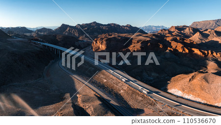 Aerial view of a road near colorful rock textures, near Vermilion Cliffs National Monument, Marble Canyon, Arizona, United States. Aerial view of a road near colorful rock textures, near Vermilion Cliffs National Monument, Marble Canyon, Arizona, United States. 110536670