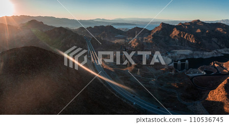 Hoover Dam on the Colorado River straddling Nevada and Arizona at dawn from above. Aerial view of Hoover Dam and the Colorado River Bridge 110536745
