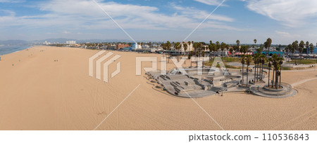 Skate board park in Venice beach with people skating by the Pacific ocean. Best and most popular skate park in the world. Skate board park in Venice beach with people skating by the Pacific ocean. Best and most popular skate park in the world. 110536843
