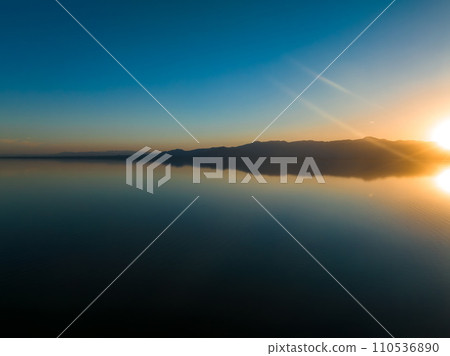 Aerial view over Salton sea in California. Huge lake in the middle of a desert at sunset. Aerial view over Salton sea in California. Huge lake in the middle of a desert at sunset. 110536890