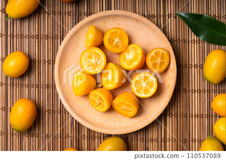 Kumquat fruits on the table. Many kumquat fruits. 110537089