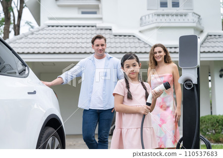 Electric vehicle and modern family at home concept. Synchronos Electric vehicle and modern family at home concept. Synchronos 110537683
