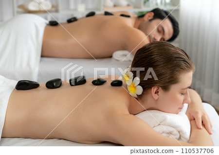 Hot stone massage at spa salon in luxury resort. Quiescent 110537706