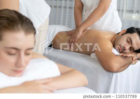 Caucasian couple customer enjoying relaxing anti-stress massage. Quiescent Caucasian couple customer enjoying relaxing anti-stress massage. Quiescent 110537789