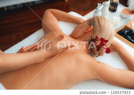 Caucasian woman customer enjoying relaxing anti-stress massage. Quiescent 110537831