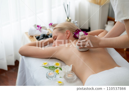 Hot herbal ball spa massage body treatment at day spa . Quiescent 110537866