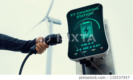 EV charger from EV car charging station at wind turbine. Persuse EV charger from EV car charging station at wind turbine. Persuse 110537957