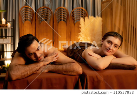 Caucasian couple customer enjoying relaxing anti-stress massage. Quiescent Caucasian couple customer enjoying relaxing anti-stress massage. Quiescent 110537958