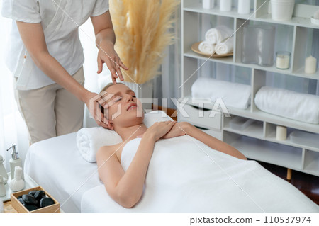 Caucasian woman enjoying relaxing anti-stress head massage. Quiescent Caucasian woman enjoying relaxing anti-stress head massage. Quiescent 110537974