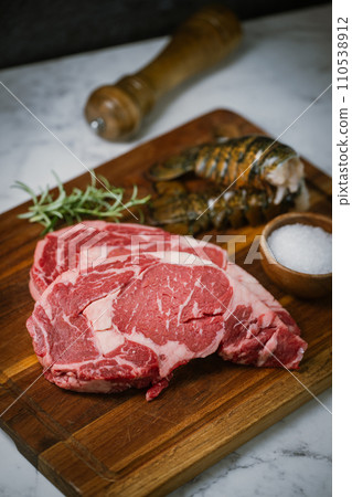fresh ribeye steak and lobster tail on white marble background fresh ribeye steak and lobster tail on white marble background 110538912