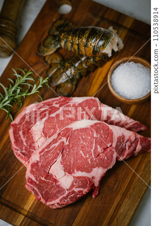 fresh ribeye steak and lobster tail on white marble background fresh ribeye steak and lobster tail on white marble background 110538914