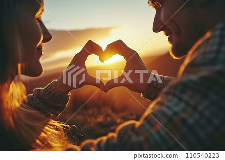 AI-generated content. Valentines day concept, Young man and woman creating heart shape by hands at sunset. Generative AI AI-generated content. Valentines day concept, Young man and woman creating heart shape by hands at sunset. Generative AI 110540223
