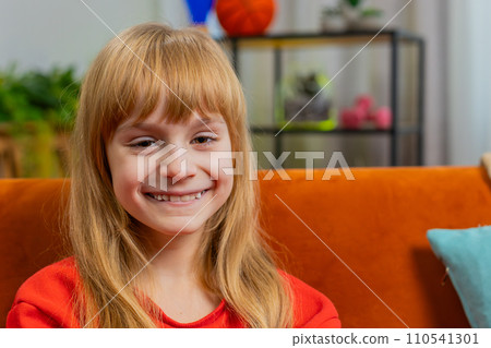 Portrait of happy smiling Caucasian preteen school girl child kid looking at camera, home play room 110541301