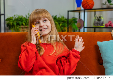 Happy surprised child girl having pleasant conversation phone call good news enjoying talking gossip Happy surprised child girl having pleasant conversation phone call good news enjoying talking gossip 110541306