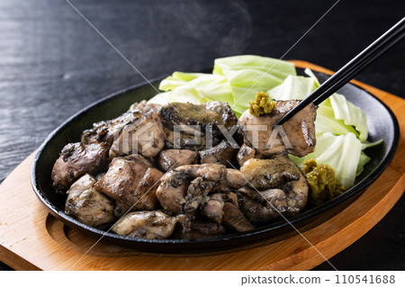 Eating free range chicken with yuzu pepper 110541688