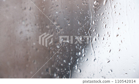 Macro of water drops on glass. Large rain drops strike window during winter shower. Pure rain drops. Macro of water drops on glass. Large rain drops strike window during winter shower. Pure rain drops. 110542014