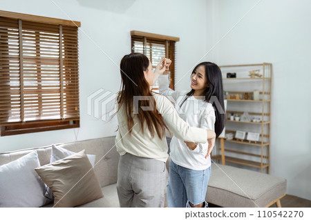 Young lesbian romantic couple in love dancing spending time together at home 110542270