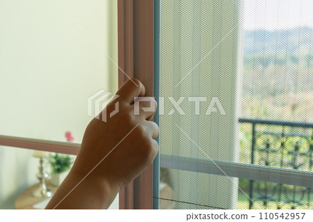 Hand hold pleated mosquito net wire screen handle on house window Hand hold pleated mosquito net wire screen handle on house window 110542957