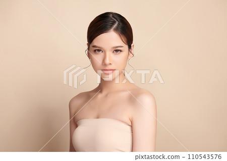 Beautiful young asian woman with clean fresh skin on beige background, Face care, Facial treatment, Cosmetology, beauty and spa, Asian women portrait. Beautiful young asian woman with clean fresh skin on beige background, Face care, Facial treatment, Cosmetology, beauty and spa, Asian women portrait. 110543576
