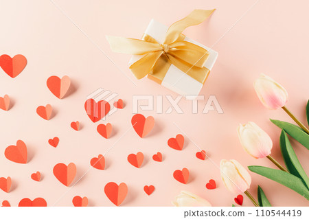 Happy Valentine Day Background. Top view flat lay of paper hearts, flower and gift box on pastel pink background surprise your loved with space for text, birthday greeting, web design banner holiday 110544419
