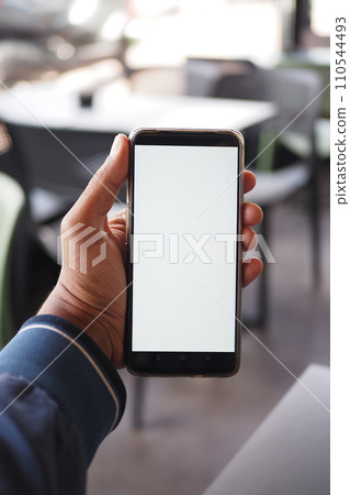 young man hand using smart phone with white screen at cafe young man hand using smart phone with white screen at cafe 110544493