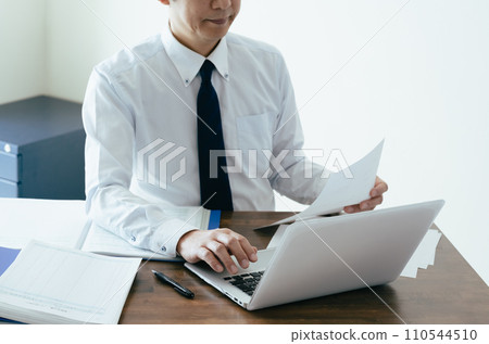 檢查分類帳的一位男性商人的手 110544510