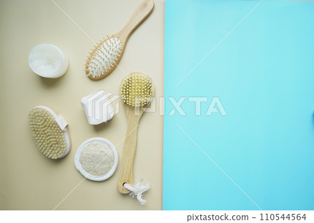 Clean towels, massage brush and bar of soap on table . 110544564