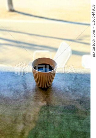 cup lit by the setting sun 110544919