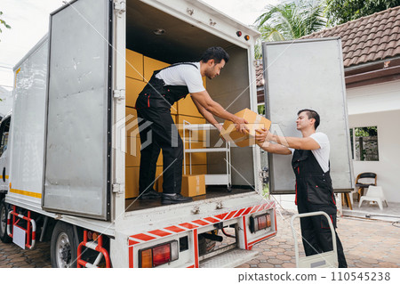 Employee team unloads boxes from truck for customer moving house showcasing the company dedication to efficient service and customer happiness. Moving Day 110545238