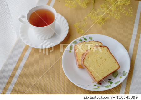 Tea time scene with lemon cake and black tea Tea time scene with lemon cake and black tea 110545399