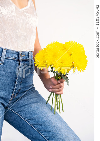 Anonymous woman holding yellow flowers. Anonymous woman holding yellow flowers. 110545642
