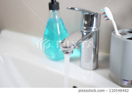 water pouring from a faucet tap slow motion  110546482