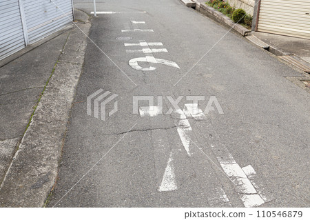 A faint stop written on the cracked road surface 110546879