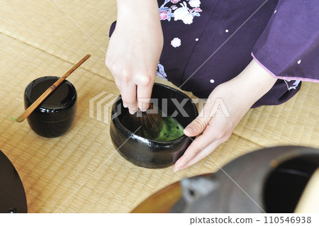 A woman putting tea A woman putting tea 110546938