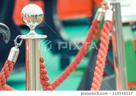 Barrier made of rope and chrome pole. Protection of celebration Barrier made of rope and chrome pole. Protection of celebration 110548517