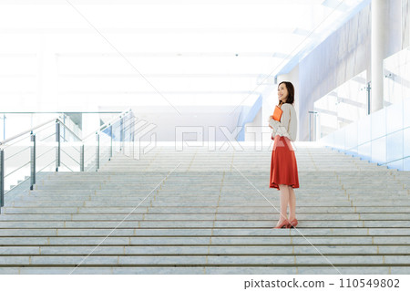 business woman standing on stairs business woman standing on stairs 110549802