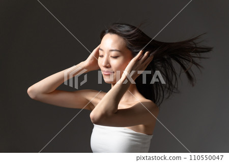 Woman brushing her hair, hair care, beauty 110550047