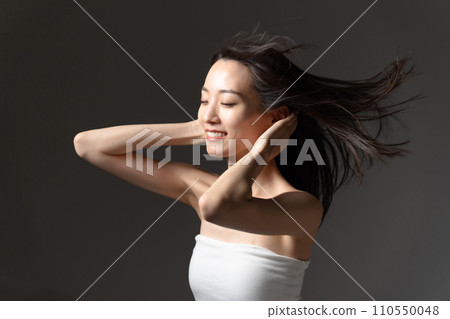 Woman brushing her hair, hair care, beauty 110550048