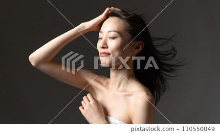 Woman brushing her hair, hair care, beauty 110550049