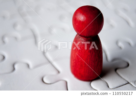 A single red wooden doll on jigsaw puzzle 110550217